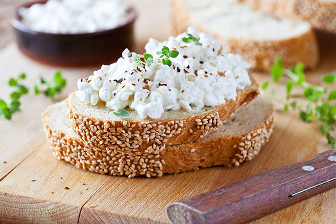 Slice of bread with fresh cottage cheese and oregano