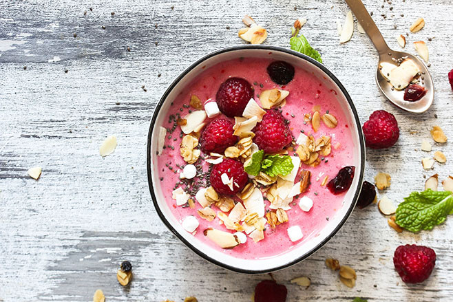 Raspberry Smoothie Bowl / Healthy breakfast concept, selective focus