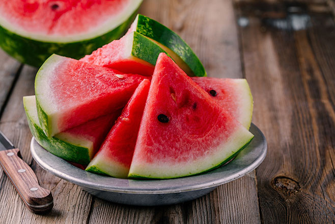 Fresh ripe sliced watermelon on wooden rustic background