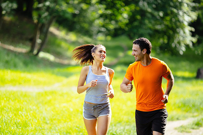 Healthy couple jogging in nature in good spirit