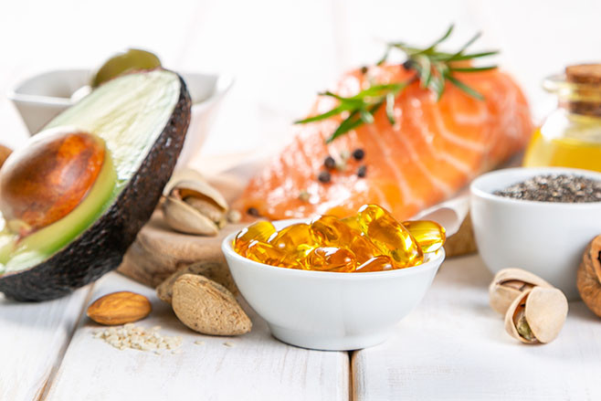 Selection of healthy unsaturated fats, omega 3 - fish, avocado, olives, nuts and seeds