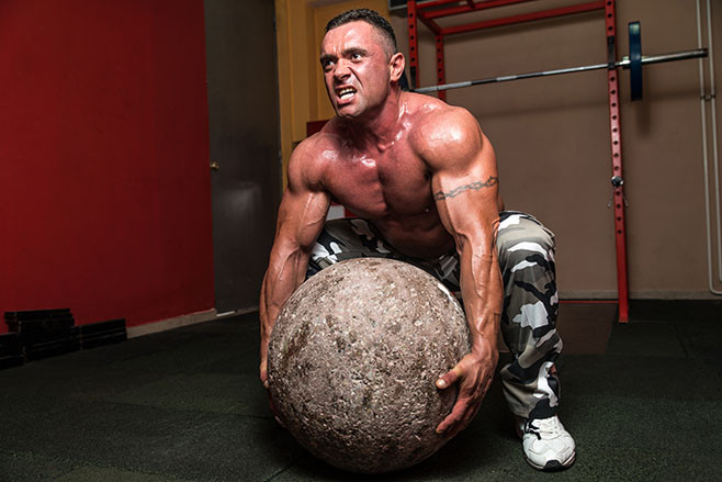 Bodybuilder Trying To Pick Up A Stone