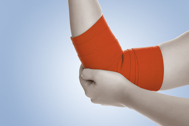 Elbow wrapped in elastic bandage,elbow pain