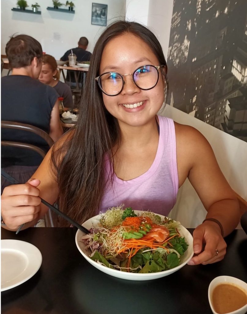 Valentina eating salad with sashimi