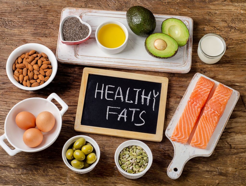 healthy fats including salmon, olives, avocado, eggs, nuts and seeds, olive oil, dairy