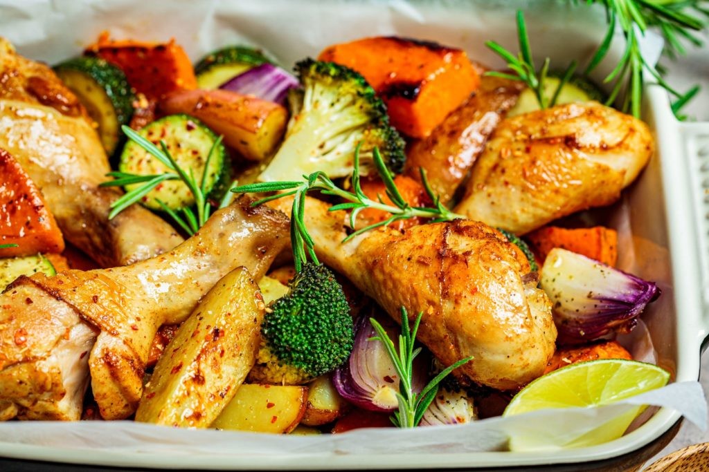 roast chicken, sweet potato and broccoli in a baking tray